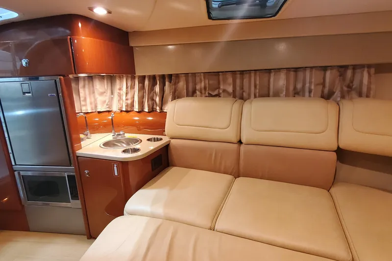  Yacht Photos Pics Luxurious interior of 2012 Formula 310 Sun Sport with kitchenette and beige seating.