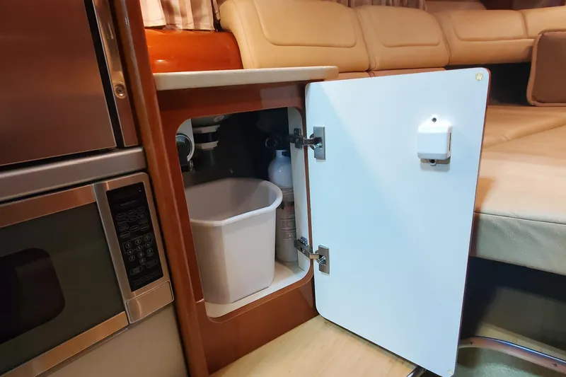  Yacht Photos Pics 2012 Formula 310 Sun Sport interior with open cabinet, microwave, and seating area.