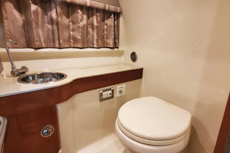  Yacht Photos Pics 2012 Formula 310 Sun Sport bathroom with sink, toilet, and curtain.