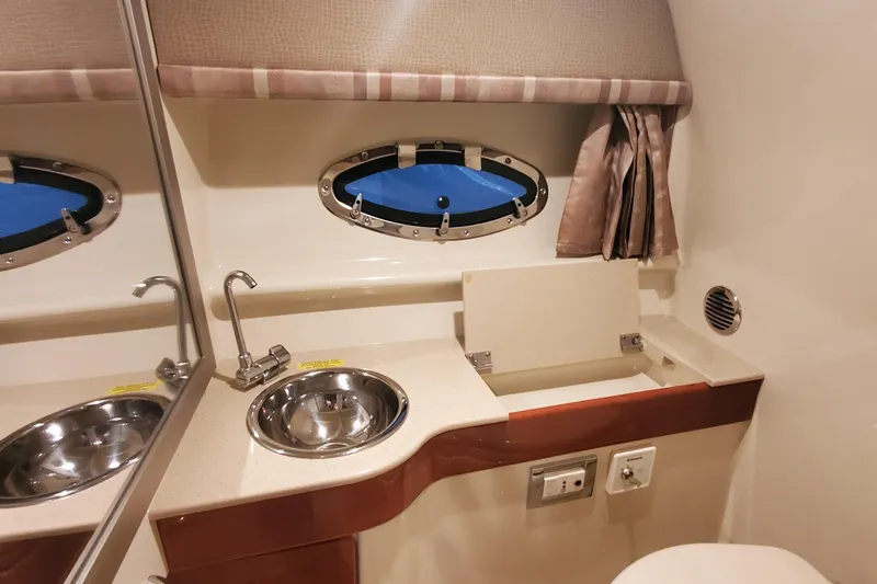  Yacht Photos Pics 2012 Formula 310 Sun Sport bathroom interior with sink and porthole window.