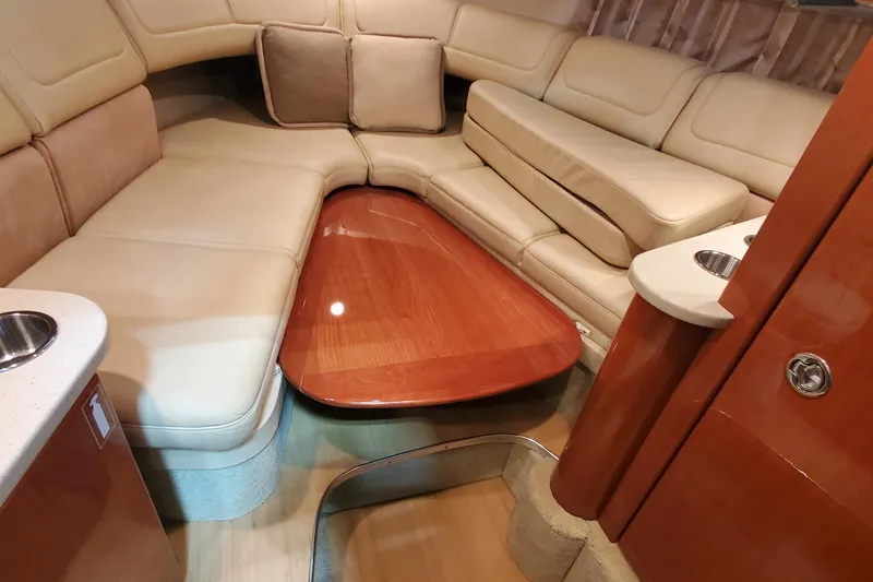  Yacht Photos Pics Luxurious interior of a 2012 Formula 310 Sun Sport boat with plush seating and wooden table.