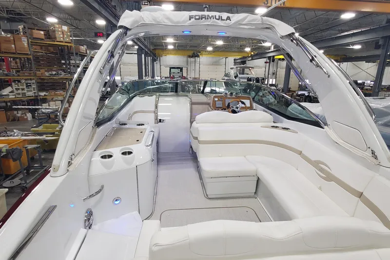  Yacht Photos Pics 2012 Formula 310 Sun Sport boat interior with white seating and modern dashboard.