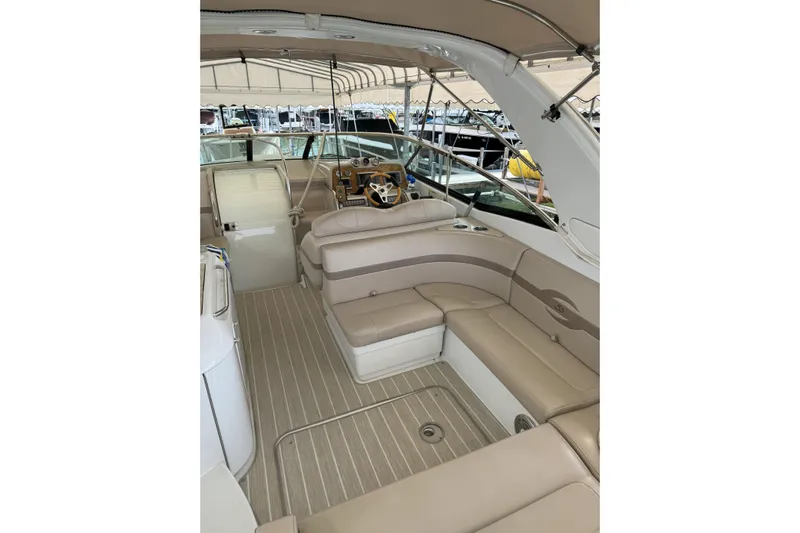  Yacht Photos Pics 2012 Formula 310 Sun Sport boat interior with beige seating and helm.