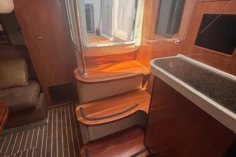  Yacht Photos Pics Interior of 2005 Four Winns 378 Vista yacht with wooden steps and seating area.