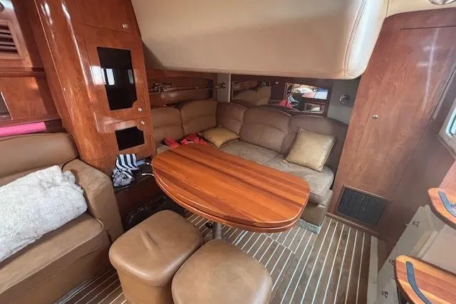  Yacht Photos Pics Interior of 2005 Four Winns 378 Vista yacht with cozy seating and wooden table.