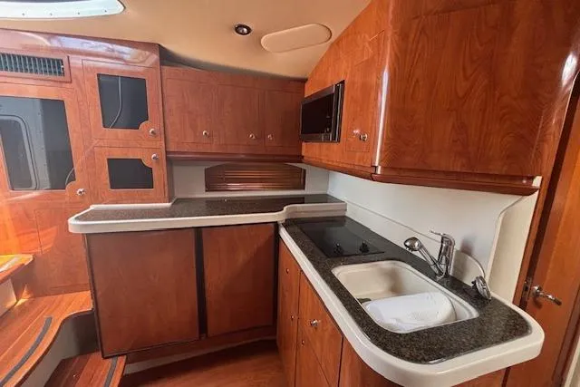  Yacht Photos Pics 2005 Four Winns 378 Vista yacht interior with wooden cabinetry and modern kitchen amenities.