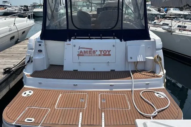  Yacht Photos Pics 2005 Four Winns 378 Vista yacht docked, featuring teak deck and covered seating area.