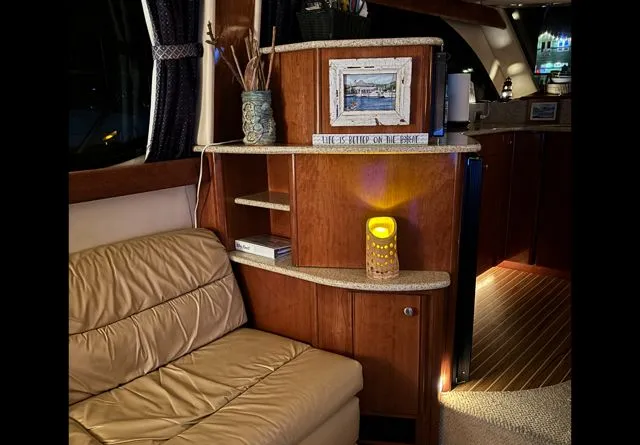 Why Knot Yacht Photos Pics Interior of a 2006 Meridian 411 Sedan yacht with cozy seating area.