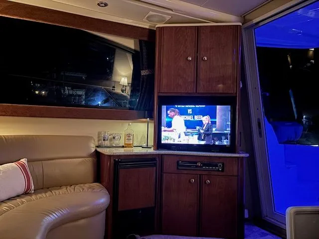 Why Knot Yacht Photos Pics Interior of a 2006 Meridian 411 Sedan yacht with TV and sofa.