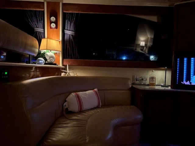 Why Knot Yacht Photos Pics Interior of a 2006 Meridian 411 Sedan yacht, warmly lit and cozy.