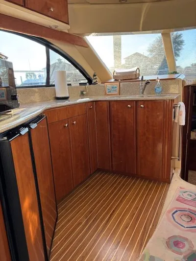 Why Knot Yacht Photos Pics Interior of 2006 Meridian 411 Sedan yacht with elegant wood cabinetry.