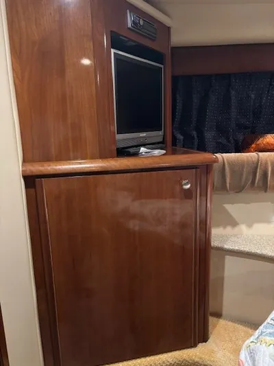 Why Knot Yacht Photos Pics Interior of a 2006 Meridian 411 Sedan with wooden cabinetry and TV.