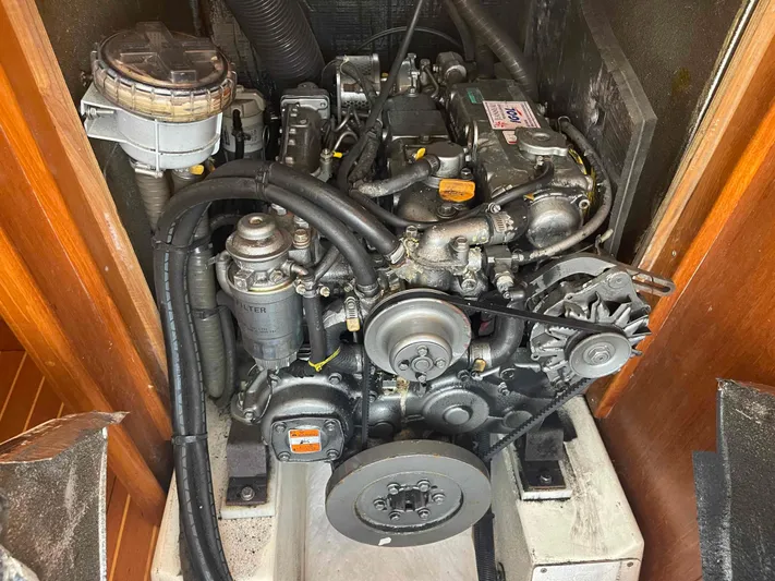 Karisma Yacht Photos Pics Engine compartment of a 2006 Jeanneau Sun Odyssey 45 sailboat, showcasing mechanical components.