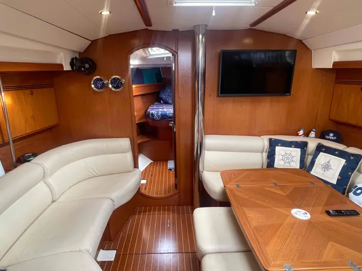 Karisma Yacht Photos Pics Interior of 2006 Jeanneau Sun Odyssey 45 yacht with elegant wood finish and cozy seating.