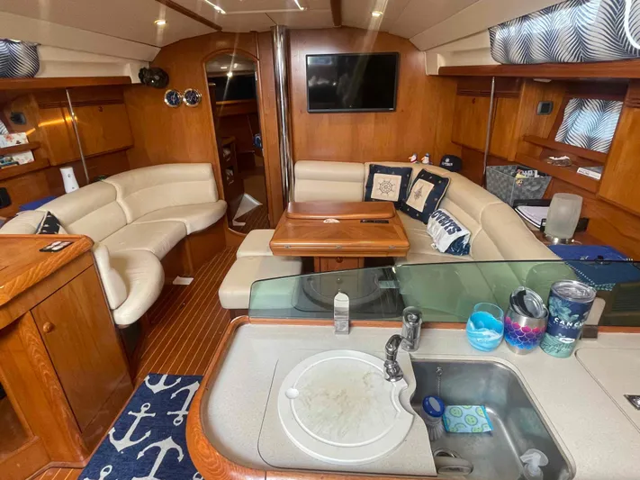Karisma Yacht Photos Pics Luxurious interior of 2006 Jeanneau Sun Odyssey 45 yacht with cozy seating and modern amenities.