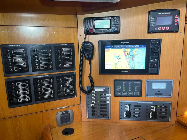 Karisma Yacht Photos Pics Control panel of 2006 Jeanneau Sun Odyssey 45 sailboat with navigation and communication equipment.