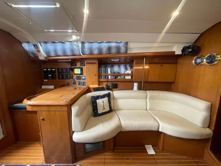 Karisma Yacht Photos Pics Interior of 2006 Jeanneau Sun Odyssey 45 yacht with wooden finish and cream seating.