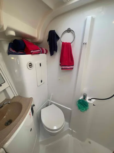 Karisma Yacht Photos Pics Bathroom of 2006 Jeanneau Sun Odyssey 45 yacht with modern fixtures and colorful towels.