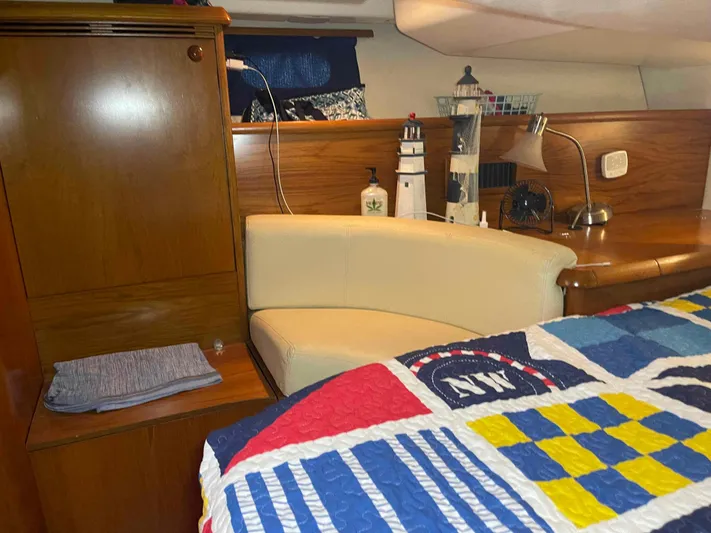 Karisma Yacht Photos Pics Cozy cabin interior of 2006 Jeanneau Sun Odyssey 45 with nautical decor and colorful bedding.