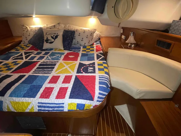 Karisma Yacht Photos Pics Cozy cabin interior of 2006 Jeanneau Sun Odyssey 45 with nautical-themed bedding.
