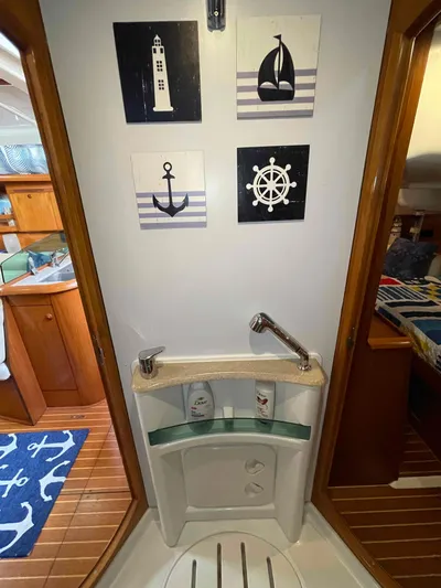 Karisma Yacht Photos Pics Bathroom interior of 2006 Jeanneau Sun Odyssey 45 sailboat with nautical decor.