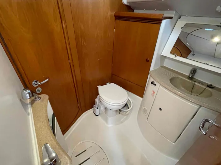 Karisma Yacht Photos Pics Bathroom interior of 2006 Jeanneau Sun Odyssey 45 yacht, featuring wooden cabinetry and compact design.