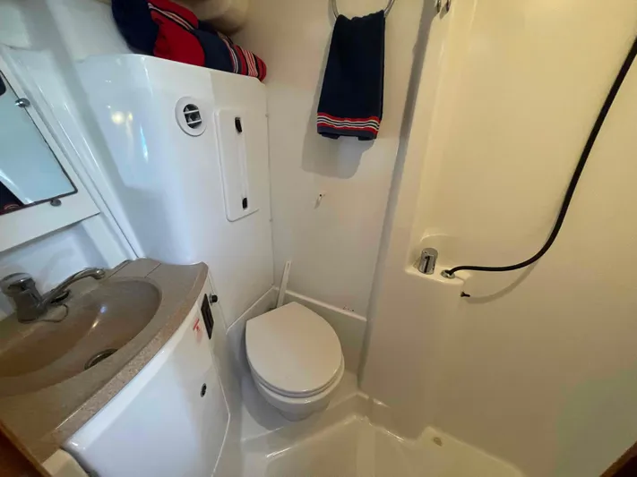 Karisma Yacht Photos Pics Bathroom interior of 2006 Jeanneau Sun Odyssey 45 yacht, featuring sink, toilet, and shower.