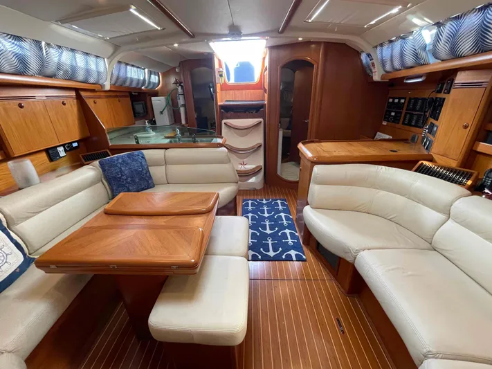 Karisma Yacht Photos Pics Luxurious 2006 Jeanneau Sun Odyssey 45 yacht interior with elegant seating and wooden finishes.