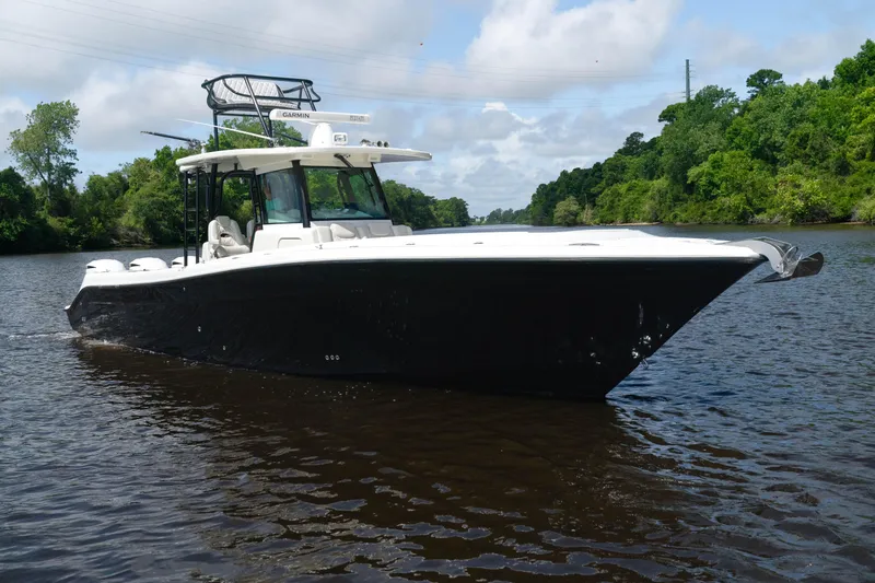  Yacht Photos Pics 2018 HCB 39 Speciale boat cruising on a river with lush green surroundings.
