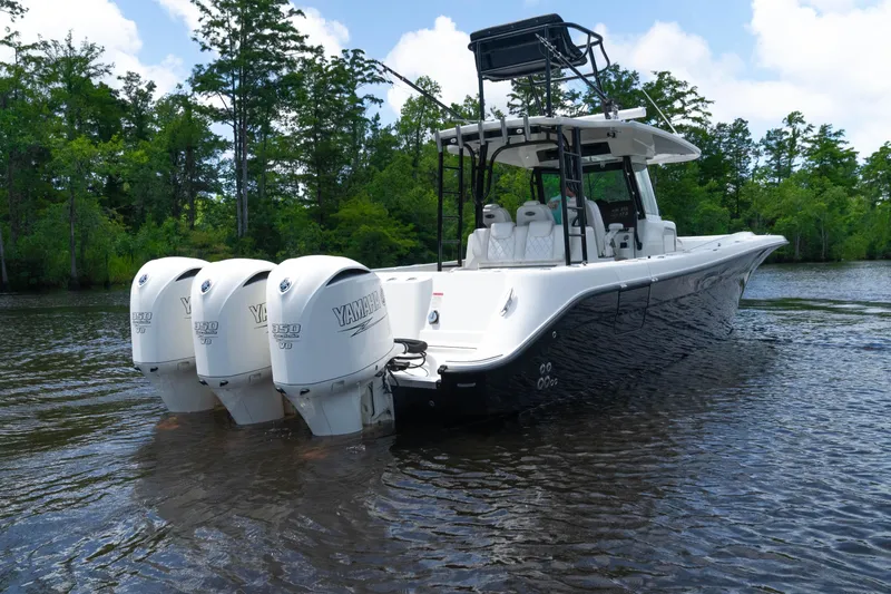  Yacht Photos Pics 2018 HCB 39 Speciale boat with triple Yamaha engines on a calm lake.
