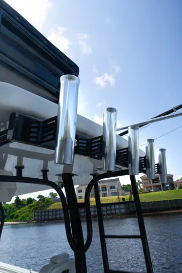  Yacht Photos Pics 2018 HCB 39 Speciale boat with rod holders, blue sky background.