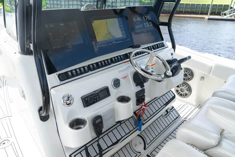  Yacht Photos Pics 2018 HCB 39 Speciale boat dashboard with navigation screens and steering wheel.