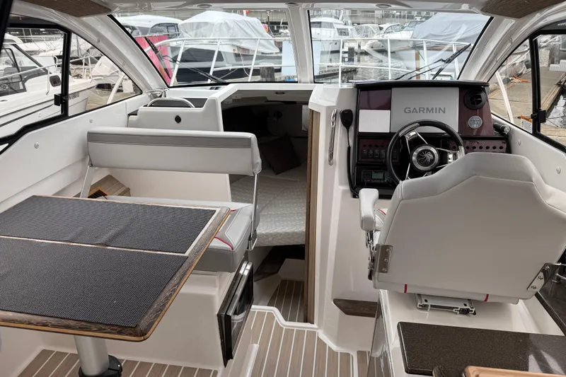  Yacht Photos Pics Interior of 2024 Solara S-250 Coupe boat with modern helm and seating area.