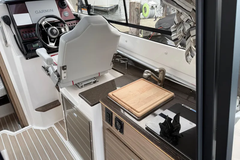  Yacht Photos Pics 2024 Solara S-250 Coupe interior with helm, cutting board, and modern amenities.