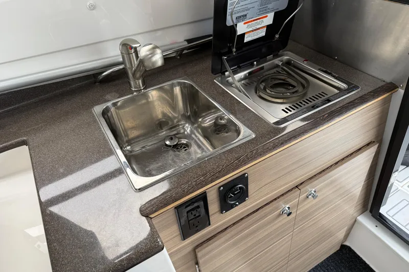  Yacht Photos Pics Compact kitchenette in 2024 Solara S-250 Coupe with sink and stove.