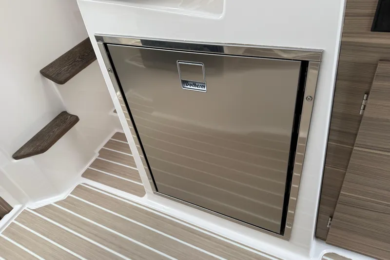  Yacht Photos Pics Stainless steel fridge in 2024 Solara S-250 Coupe boat interior with wood accents.