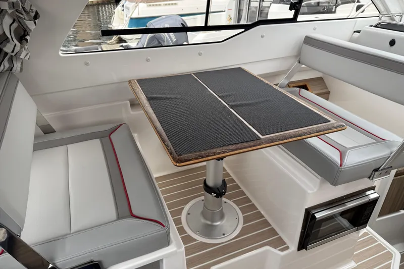  Yacht Photos Pics 2024 Solara S-250 Coupe interior with sleek seating and modern table design.