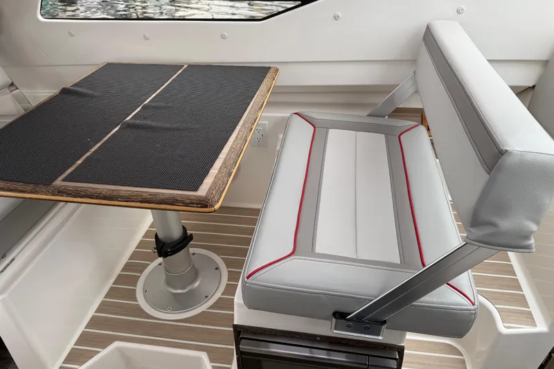  Yacht Photos Pics 2024 Solara S-250 Coupe interior with sleek seating and modern table design.