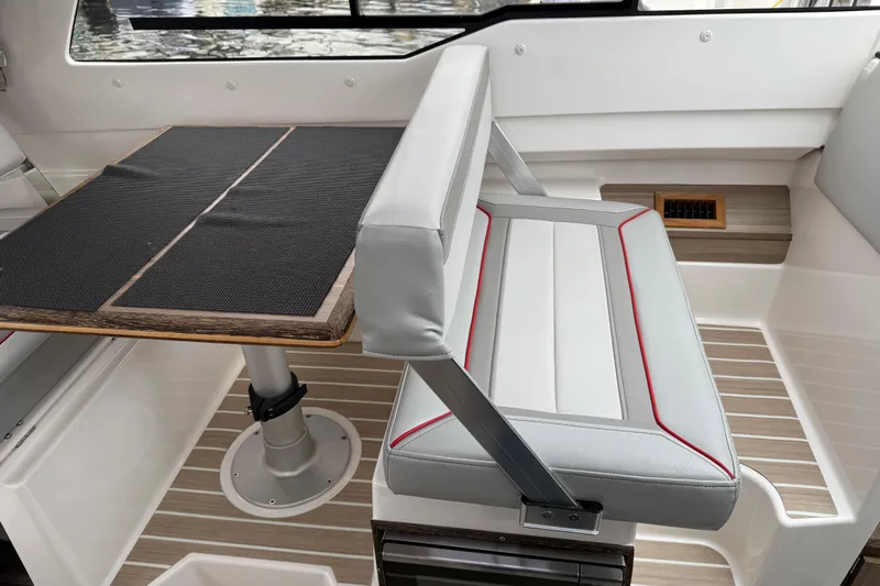  Yacht Photos Pics 2024 Solara S-250 Coupe interior with sleek seating and modern table design.