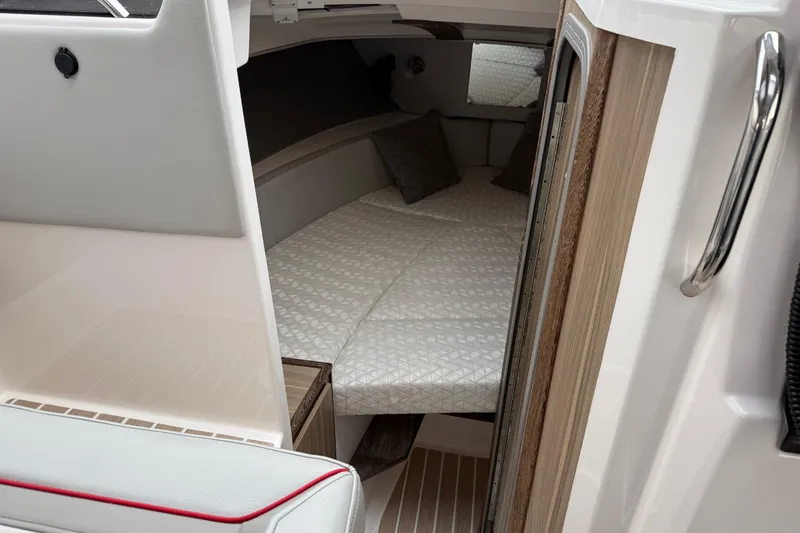  Yacht Photos Pics 2024 Solara S-250 Coupe interior cabin with cozy bedding and modern design.