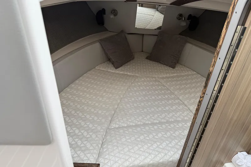  Yacht Photos Pics 2024 Solara S-250 Coupe cabin interior with cozy bedding and pillows.