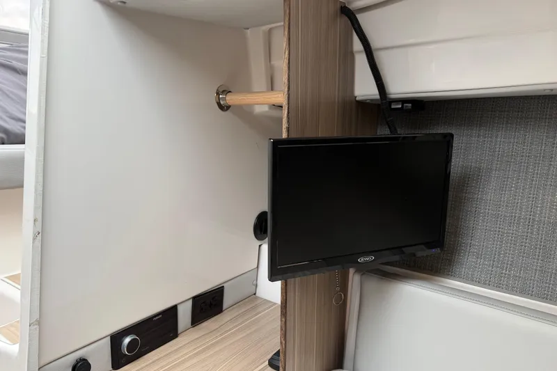  Yacht Photos Pics 2024 Solara S-250 Coupe interior with mounted TV and modern design elements.