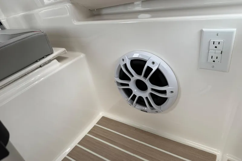  Yacht Photos Pics 2024 Solara S-250 Coupe interior with speaker and power outlet on sleek paneling.