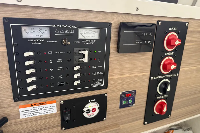  Yacht Photos Pics Electrical control panel in a 2024 Solara S-250 Coupe, featuring various switches and gauges.