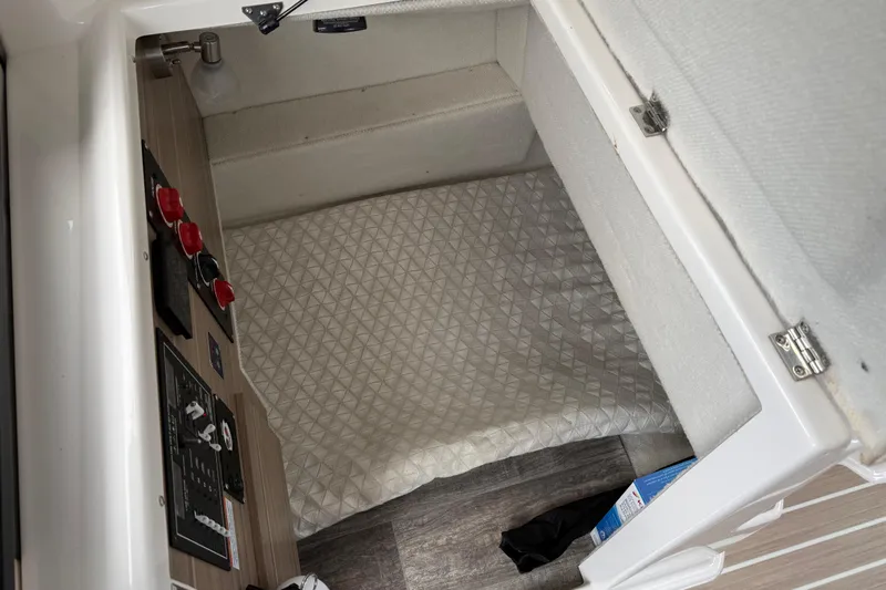  Yacht Photos Pics 2024 Solara S-250 Coupe interior cabin with control panel and cushioned bedding.