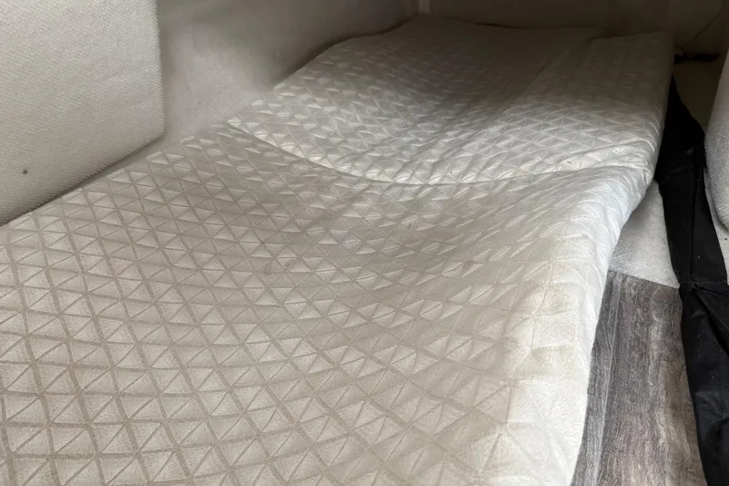  Yacht Photos Pics 2024 Solara S-250 Coupe interior with quilted upholstery and wood-like flooring.