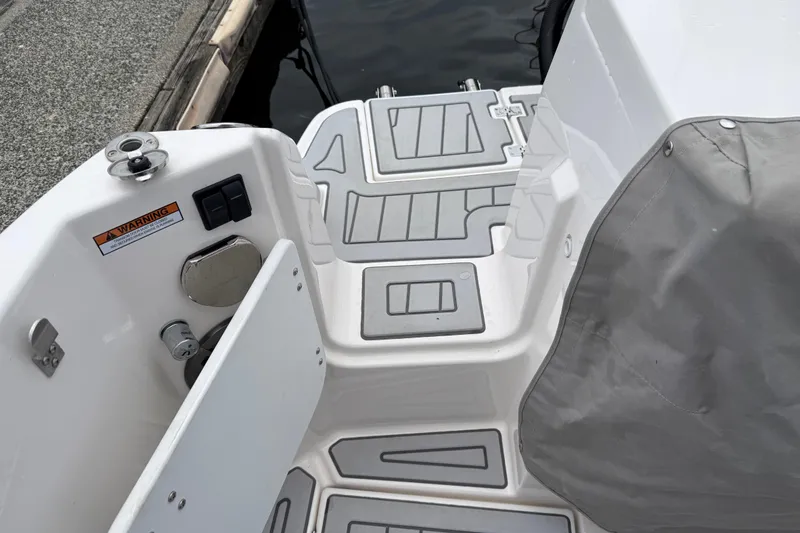  Yacht Photos Pics 2024 Solara S-250 Coupe boat deck with non-slip surface and covered seating area.