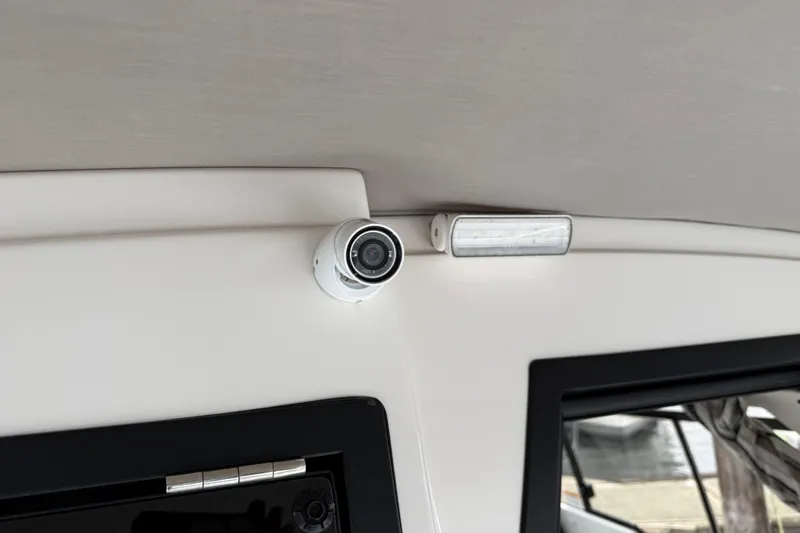  Yacht Photos Pics 2024 Solara S-250 Coupe interior with security camera and light fixture.