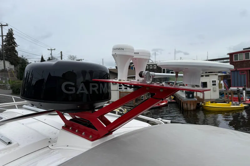  Yacht Photos Pics Rooftop antennas on a 2024 Solara S-250 Coupe, featuring Garmin technology by a waterfront.