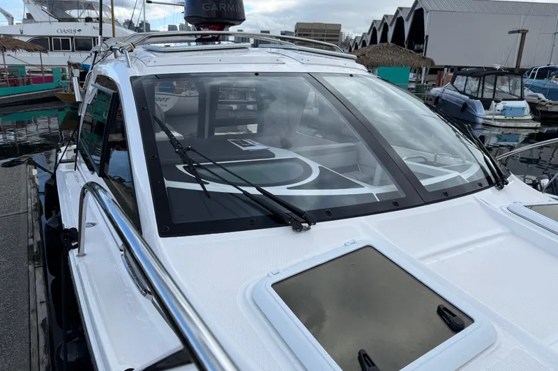  Yacht Photos Pics 2024 Solara S-250 Coupe boat docked at marina, featuring sleek design and modern equipment.